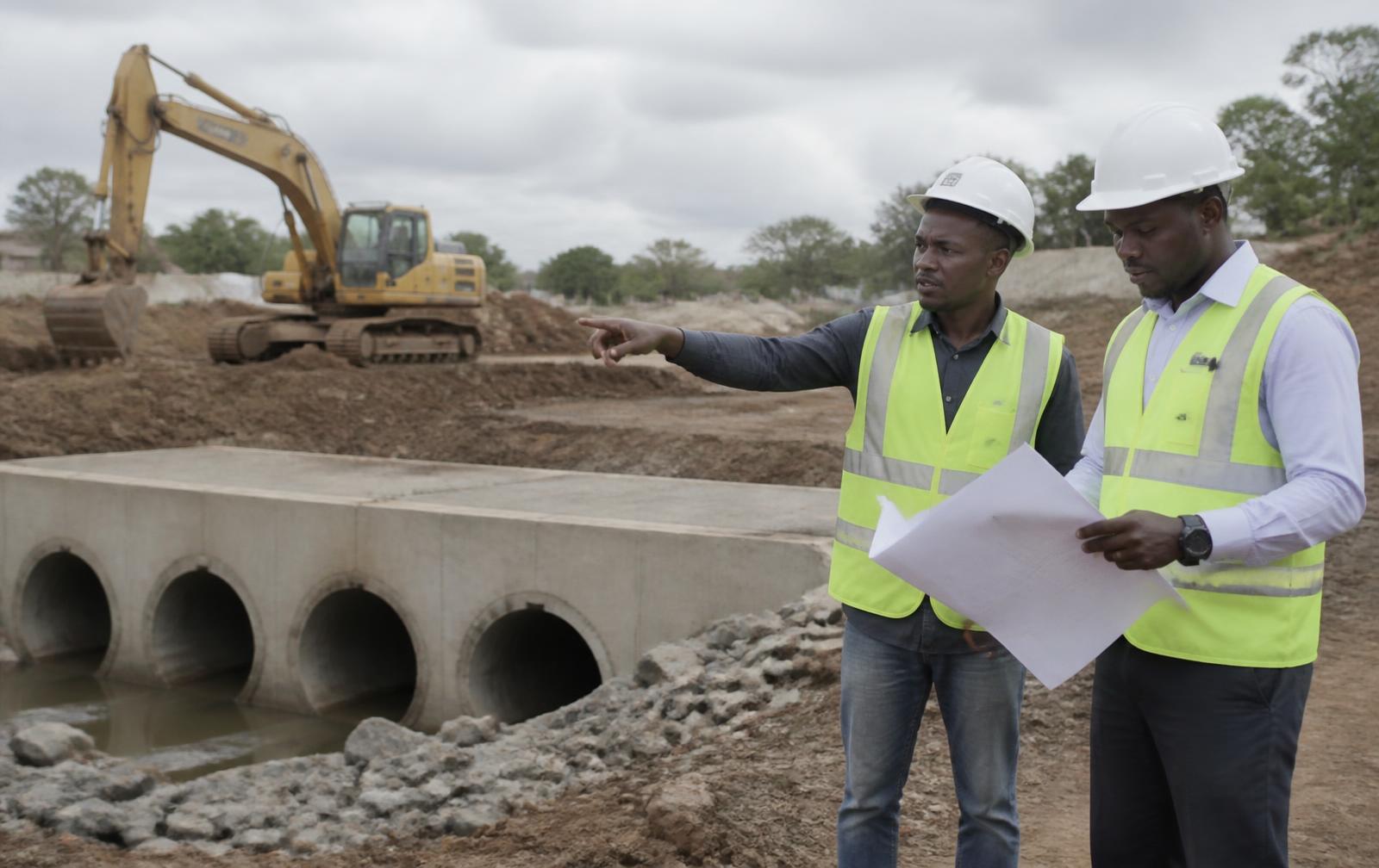 Engineers reviewing drawings at an infrastructure works site in Kenya